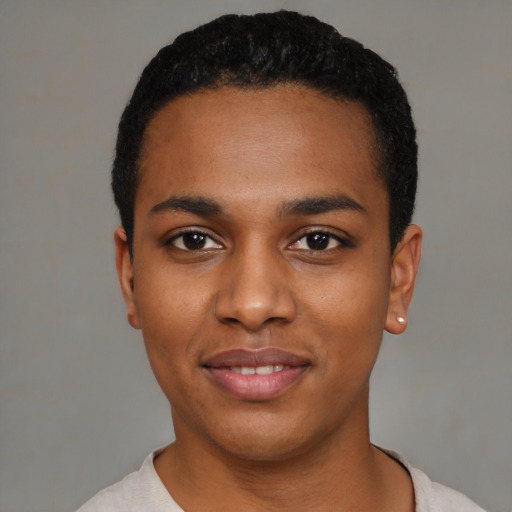 Joyful black young-adult male with short  black hair and brown eyes