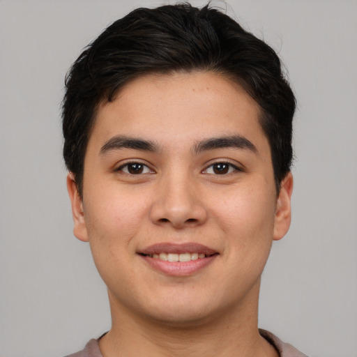 Joyful asian young-adult male with short  brown hair and brown eyes