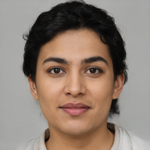 Joyful latino young-adult female with short  brown hair and brown eyes