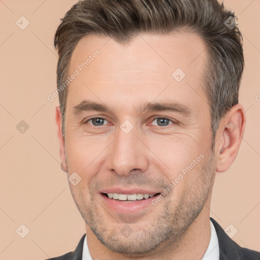 Joyful white adult male with short  brown hair and brown eyes