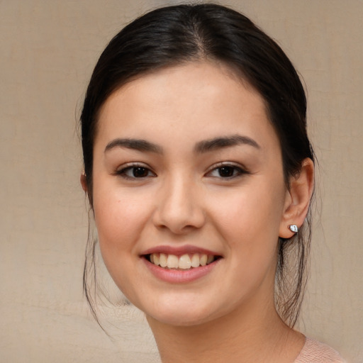 Joyful asian young-adult female with long  brown hair and brown eyes