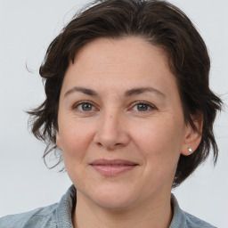 Joyful white adult female with medium  brown hair and brown eyes