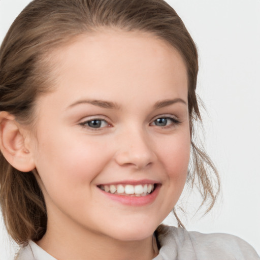 Joyful white child female with medium  brown hair and grey eyes