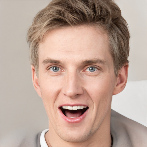 Joyful white adult male with short  brown hair and grey eyes