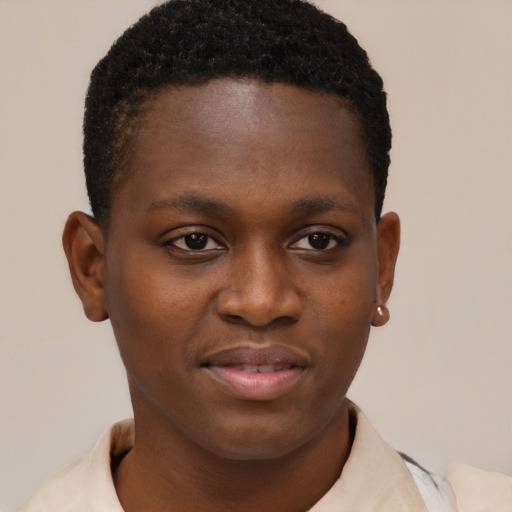 Joyful black young-adult male with short  brown hair and brown eyes