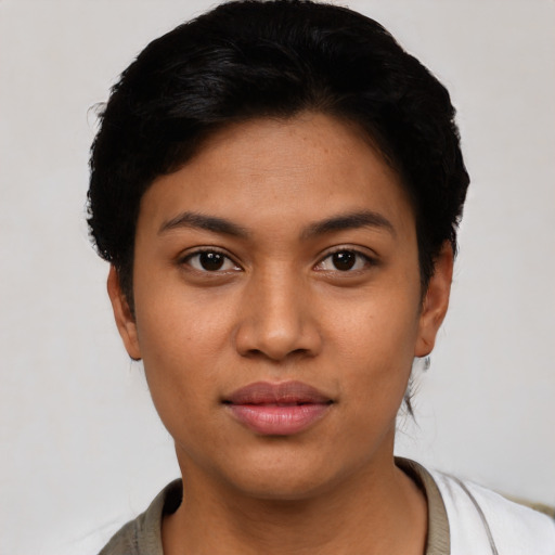 Joyful latino young-adult female with short  black hair and brown eyes