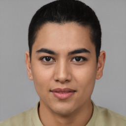 Joyful latino young-adult male with short  black hair and brown eyes