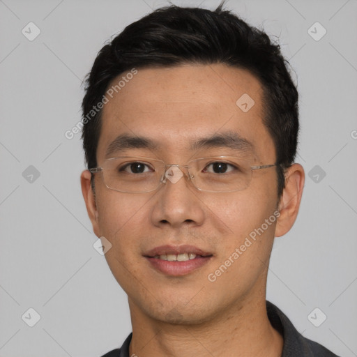 Joyful asian young-adult male with short  black hair and brown eyes