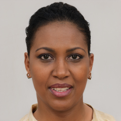 Joyful black young-adult female with short  black hair and brown eyes