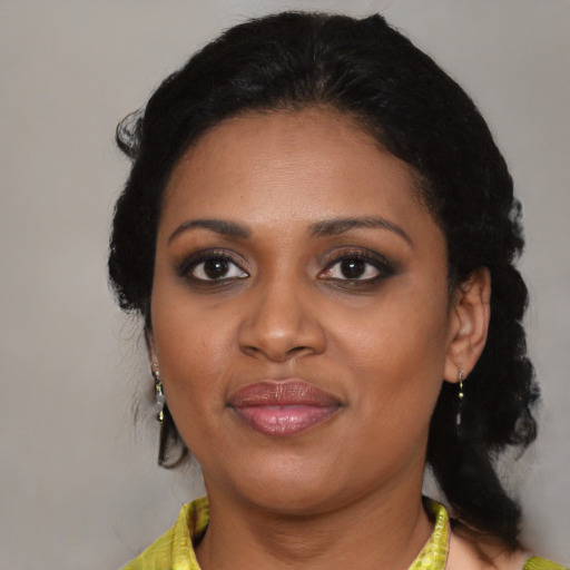 Joyful black young-adult female with medium  black hair and brown eyes