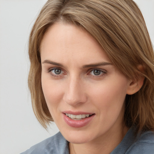 Joyful white young-adult female with medium  brown hair and blue eyes