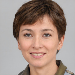 Joyful white young-adult female with short  brown hair and grey eyes