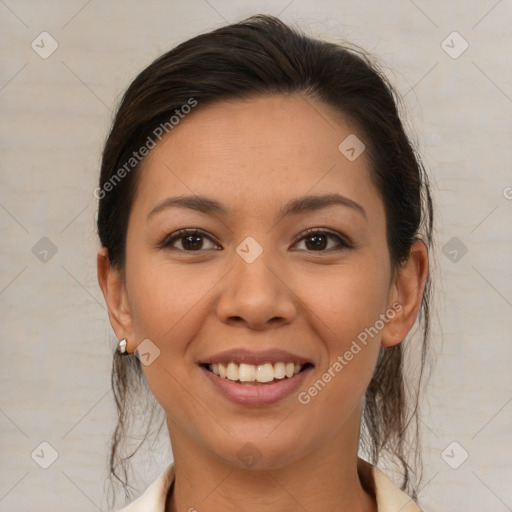 Joyful latino young-adult female with medium  brown hair and brown eyes