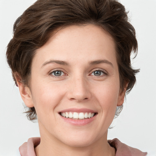 Joyful white young-adult female with short  brown hair and grey eyes