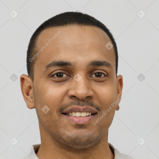 Joyful latino young-adult male with short  brown hair and brown eyes