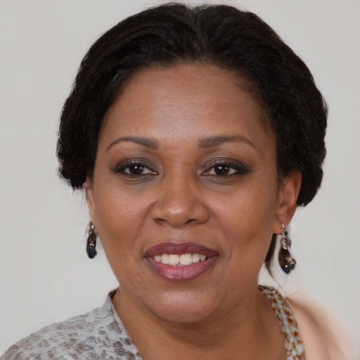 Joyful black adult female with short  brown hair and brown eyes