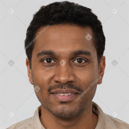 Joyful black young-adult male with short  black hair and brown eyes