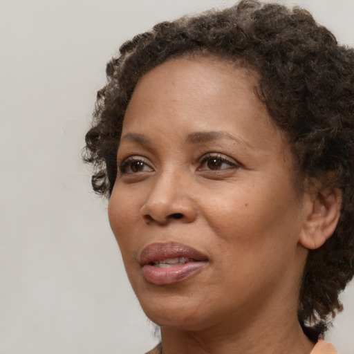 Neutral black adult female with medium  brown hair and brown eyes