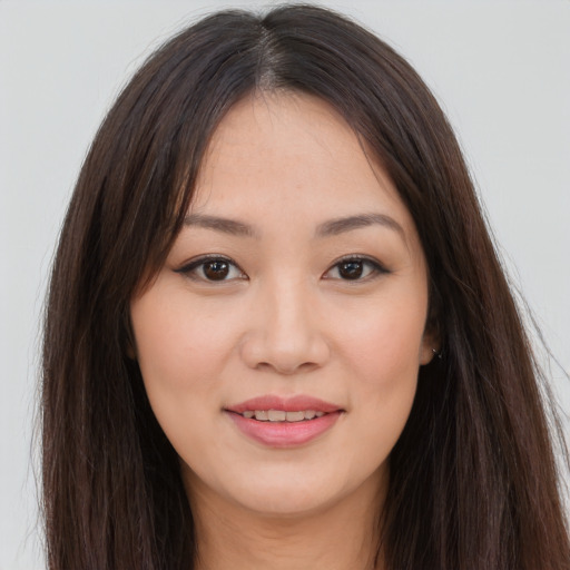 Joyful asian young-adult female with long  brown hair and brown eyes