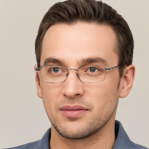 Joyful white adult male with short  brown hair and grey eyes