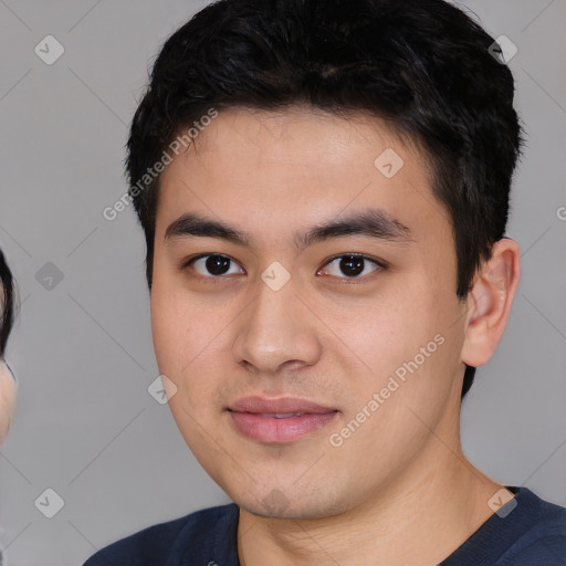 Joyful asian young-adult male with short  black hair and brown eyes