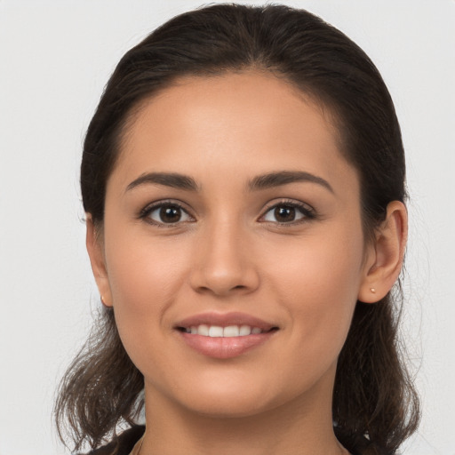 Joyful white young-adult female with long  brown hair and brown eyes