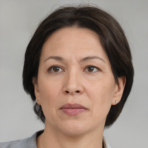 Joyful white adult female with medium  brown hair and brown eyes
