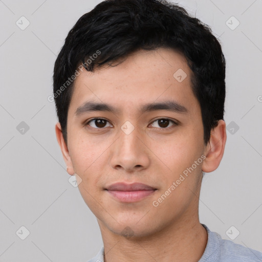 Joyful asian young-adult male with short  black hair and brown eyes