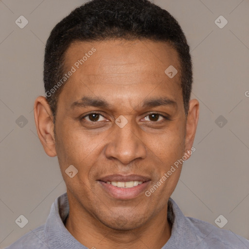 Joyful latino adult male with short  brown hair and brown eyes