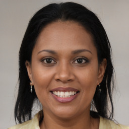 Joyful black young-adult female with medium  brown hair and brown eyes