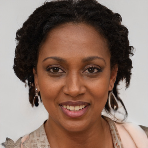 Joyful black adult female with medium  brown hair and brown eyes