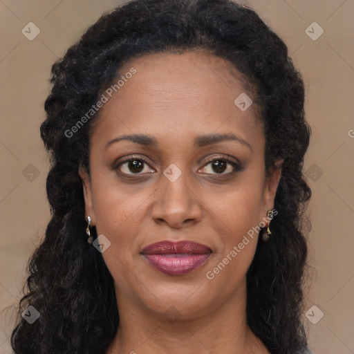 Joyful black young-adult female with long  brown hair and brown eyes