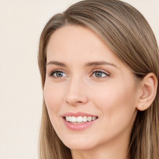 Joyful white young-adult female with long  brown hair and grey eyes