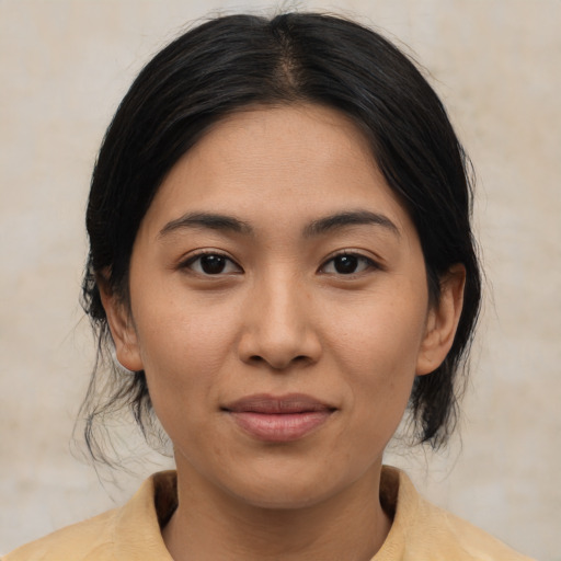 Joyful asian young-adult female with medium  brown hair and brown eyes