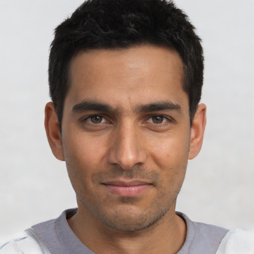 Joyful white young-adult male with short  black hair and brown eyes