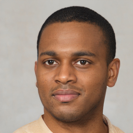 Joyful latino young-adult male with short  brown hair and brown eyes