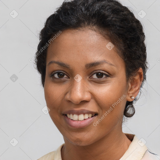 Joyful black young-adult female with short  brown hair and brown eyes