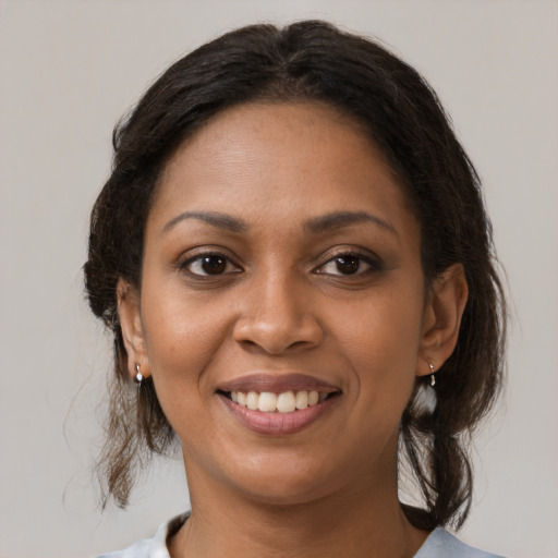 Joyful black young-adult female with medium  brown hair and brown eyes
