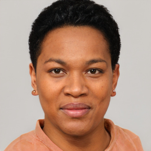 Joyful black young-adult female with short  black hair and brown eyes