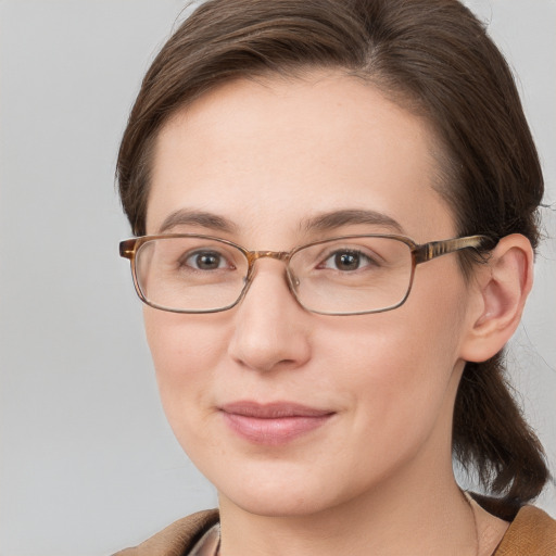 Joyful white young-adult female with medium  brown hair and blue eyes