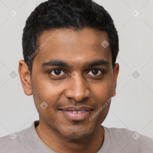 Joyful black young-adult male with short  black hair and brown eyes