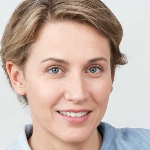 Joyful white young-adult female with medium  brown hair and blue eyes