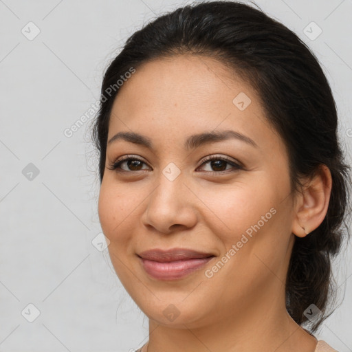 Joyful latino young-adult female with medium  brown hair and brown eyes