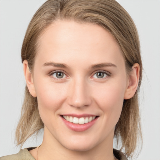 Joyful white young-adult female with medium  brown hair and grey eyes