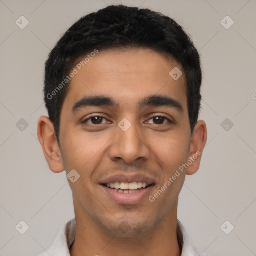 Joyful latino young-adult male with short  black hair and brown eyes