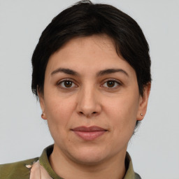 Joyful white adult female with medium  brown hair and brown eyes