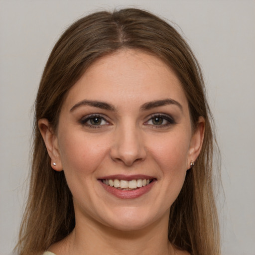 Joyful white young-adult female with long  brown hair and grey eyes