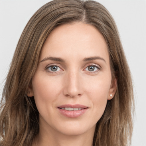 Joyful white young-adult female with long  brown hair and grey eyes