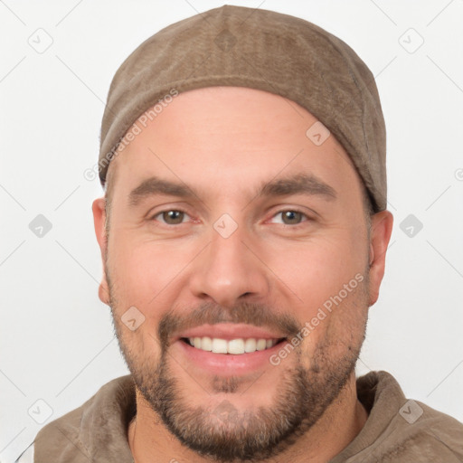 Joyful white young-adult male with short  brown hair and brown eyes