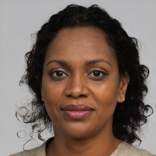 Joyful black young-adult female with medium  black hair and brown eyes